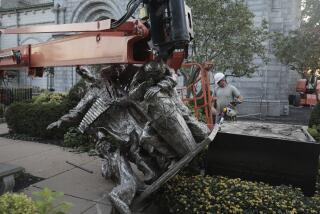 "The Angel of Harmony" sculpture damaged outside the Cathedral Basilica of St. Louis on Wednesday, Sept. 18, 2024 in St. Louis. (Christian Gooden/St. Louis Post-Dispatch via AP)