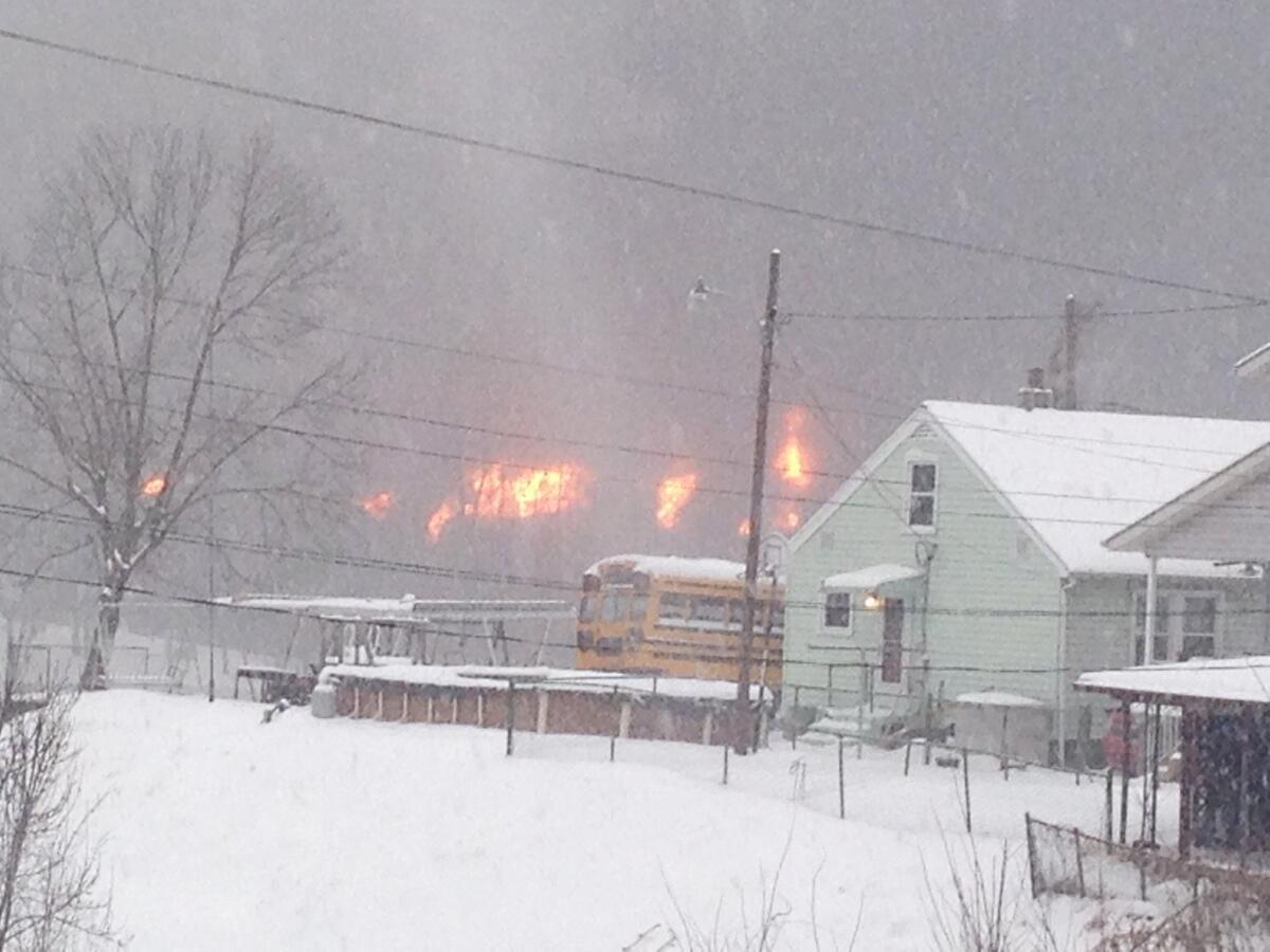 A train derailed and exploded in West Virginia on Monday. Crude oil from the train is leaking into the Kanawha River, officials said.