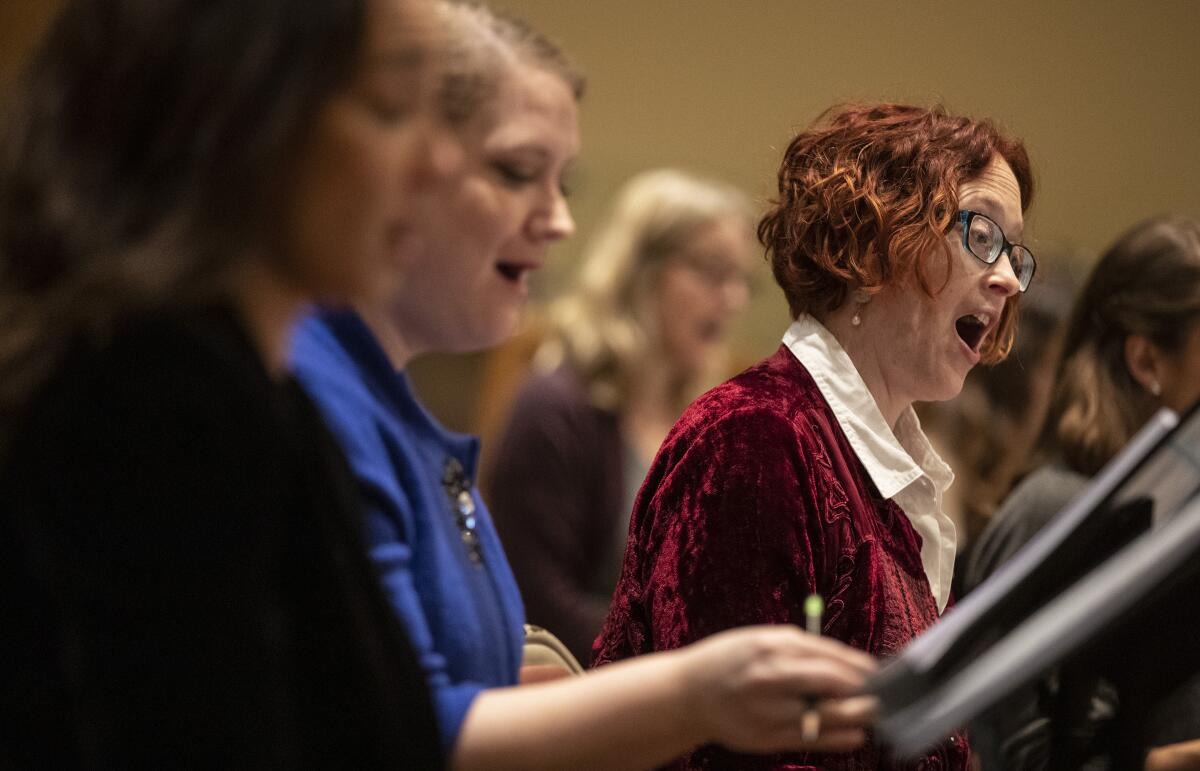 Los Angeles Master Chorale soprano Claire Fedoruk, right, rehearses “Sunrise: A Song of Two Humans."