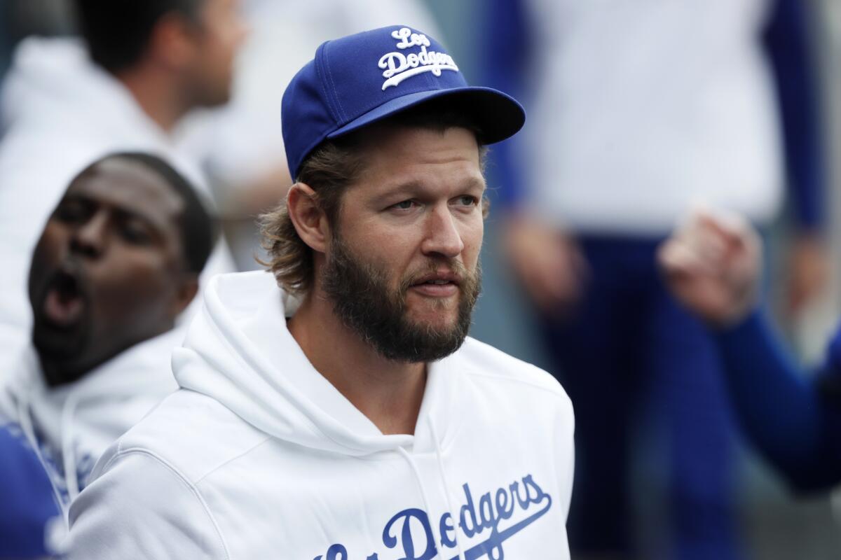 Dodgers starting pitcher Clayton Kershaw stands in the dugout before a game.