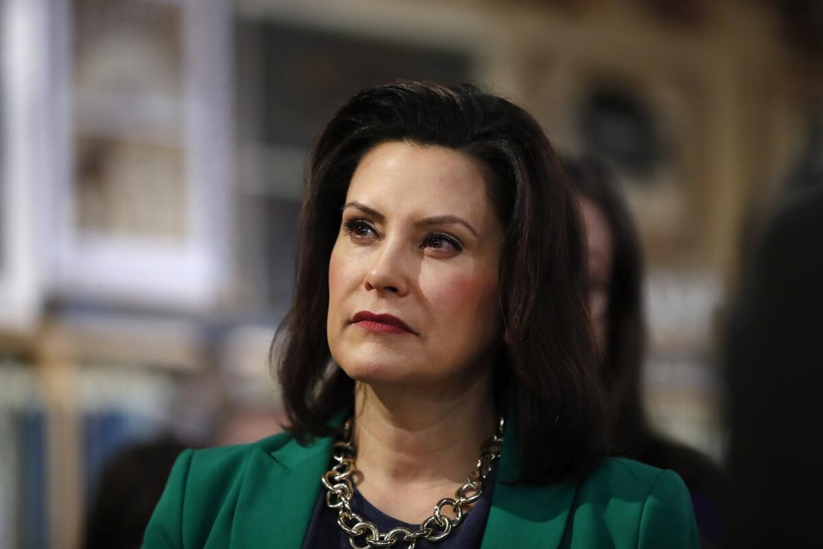 FILE - In this March 18, 2019, file photo, Michigan Gov. Gretchen Whitmer listens to Democratic presidential candidate Sen. Kirsten Gillibrand, D-N.Y., in Clawson, Mich. Whitmer is moving to make Michigan the first state to ban flavored e-cigarettes. The Democrat announced Wednesday, Sept. 4 that she ordered the state health department to issue emergency rules. They will prohibit the sale and misleading marketing of flavored nicotine vaping products. (AP Photo/Paul Sancya, File)