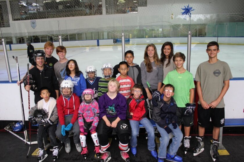 The San Diego Chill ice hockey program was founded by Carmel Valley’s Isaiah Granet, right in green. Courtesy photo