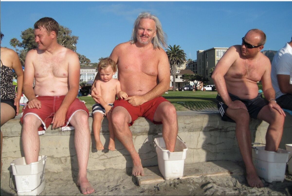 Charles Bower (center) recovers from a stingray sting at La Jolla Shores.