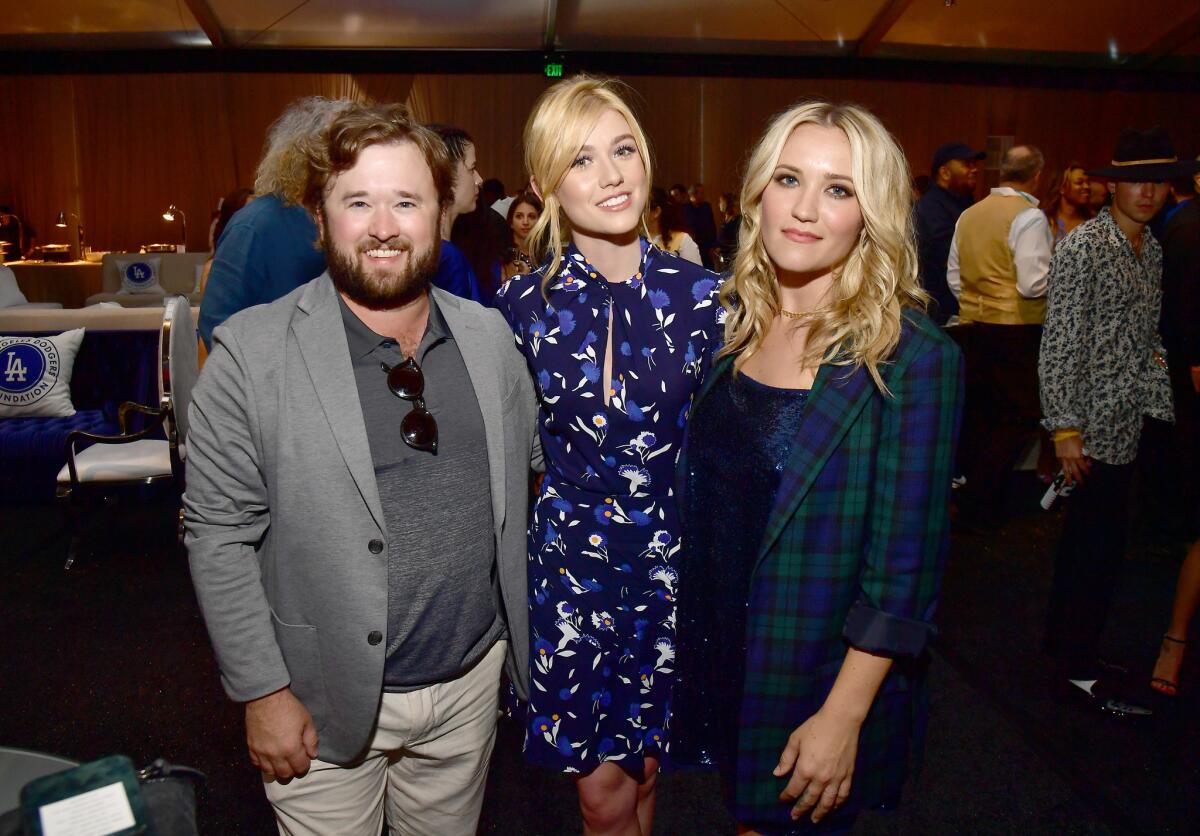 Haley Joel Osment, left, Katherine McNamara and Emily Osment at Dodger Stadium.