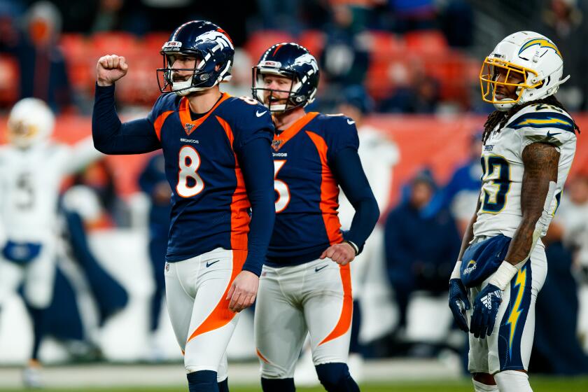 DENVER, CO - DECEMBER 1: Place kicker Brandon McManus #8 of the Denver Broncos celebrates his game-winning, 53-yard field goal with holder Colby Wadman #6 as safety Rayshawn Jenkins #23 of the Los Angeles Chargers looks on at Empower Field at Mile High on December 1, 2019 in Denver, Colorado. The Broncos defeated the Chargers 23-20. (Photo by Justin Edmonds/Getty Images)