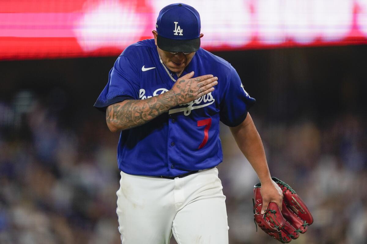 Los Angeles Dodgers starting pitcher Julio Urias reacts while coming off the field.