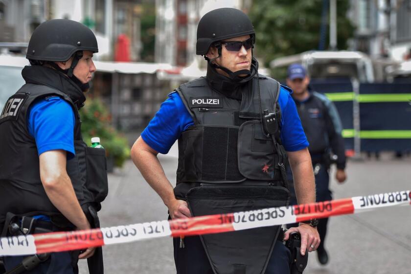 Swiss policemen stand guard behind a police cordon in the old quarter of Schaffhausen, northern Switzerland on July 24, 2017, after a man armed with a chainsaw injured at least five people in an attack. The attacker has been identified and is believed to be on the run in a vehicle, ATS news agency said, citing the police. According to the agency, police have said the attack was not "a terrorist act." / AFP PHOTO / MICHAEL BUHOLZERMICHAEL BUHOLZER/AFP/Getty Images ** OUTS - ELSENT, FPG, CM - OUTS * NM, PH, VA if sourced by CT, LA or MoD **