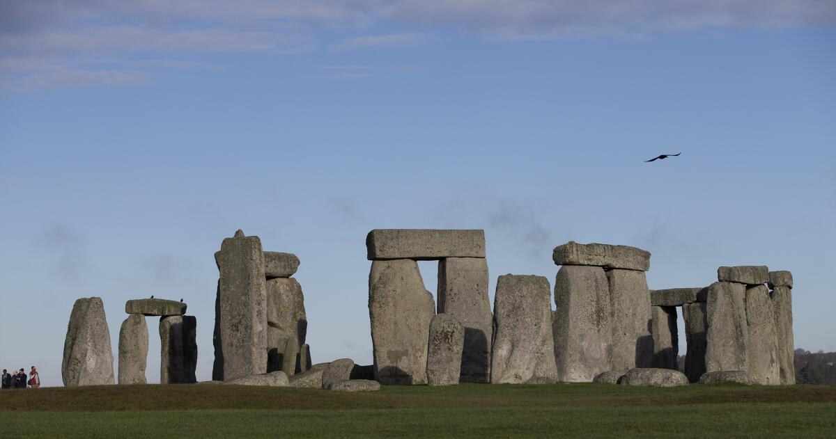 Visitors take photographs of Stonehenge, England.