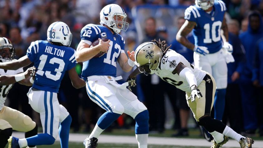 Indianapolis Colts quarterback Andrew Luck is tackled by Brian Dixon (20) of the New Orleans Saints in a 2015 game.