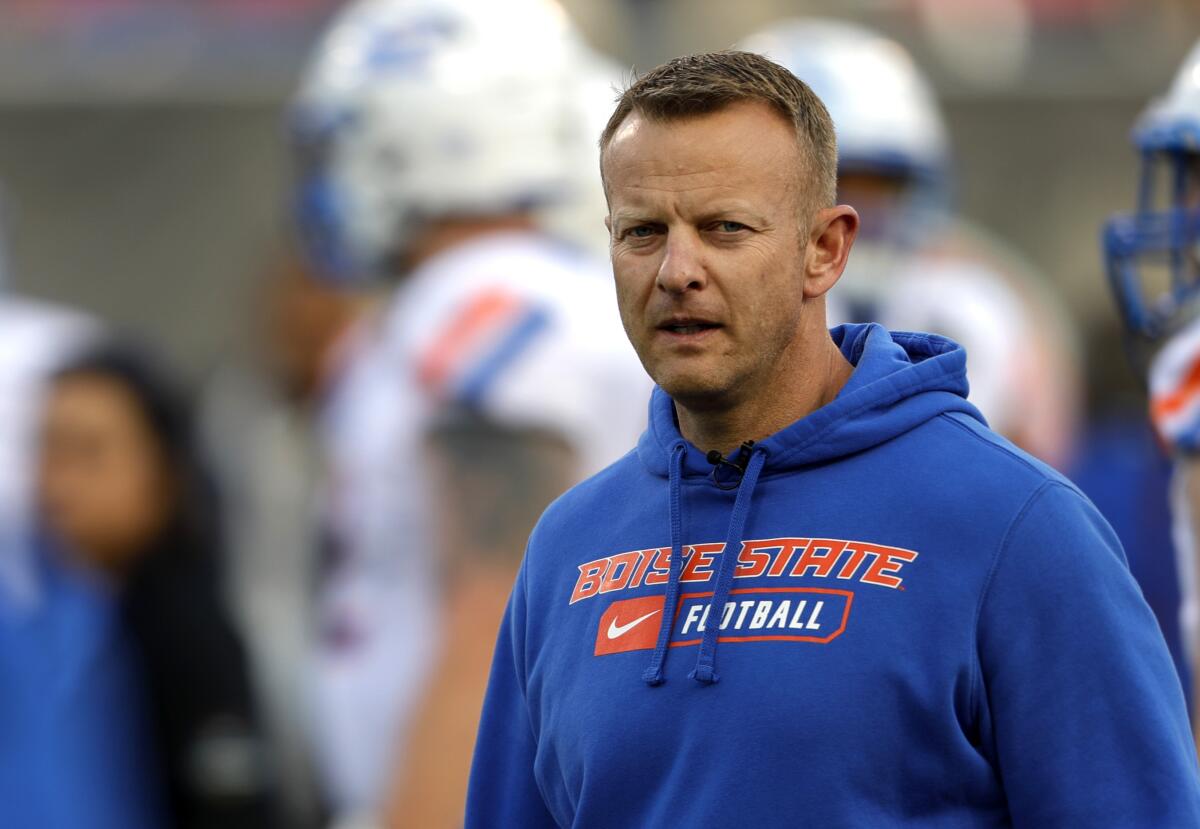 Boise State coach Bryan Harsin watches his players warm up before a game against Washington.