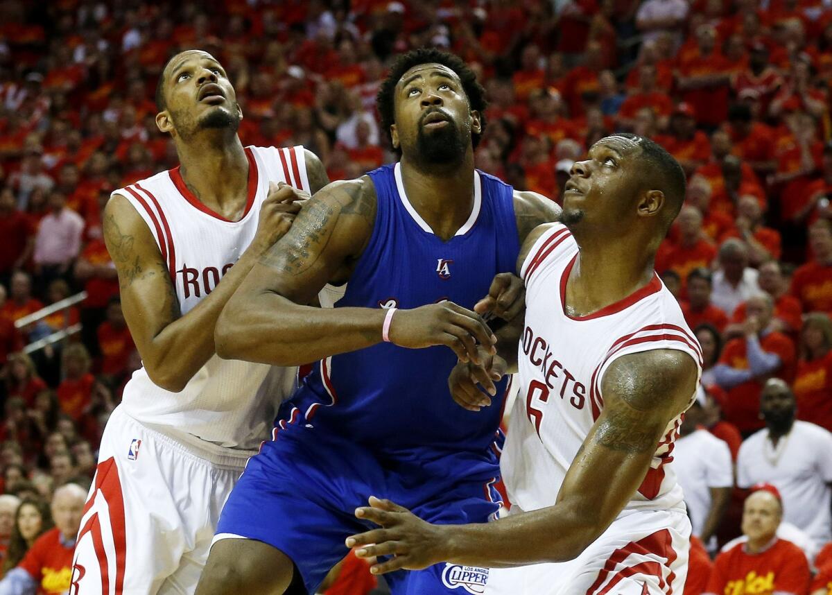 DeAndre Jordan vies for position with Houston's Terrence Jones (No. 6) and Trevor Ariza on May 17.