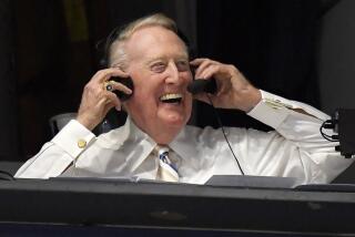 Dodgers Hall of Fame announcer Vin Scully puts his headset on prior to a baseball game