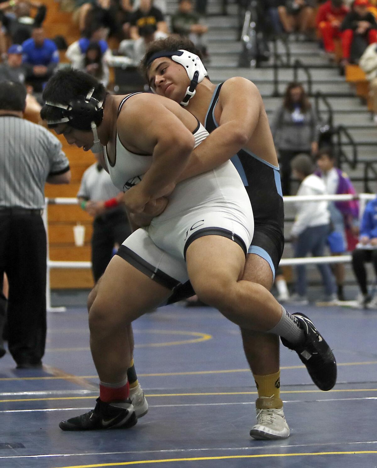 Corona del Mar's Emilio Franco competes against Northview's Rigo Estrada in a 220-pound match during the Five Counties wrestling tournament at Fountain Valley High on Saturday.