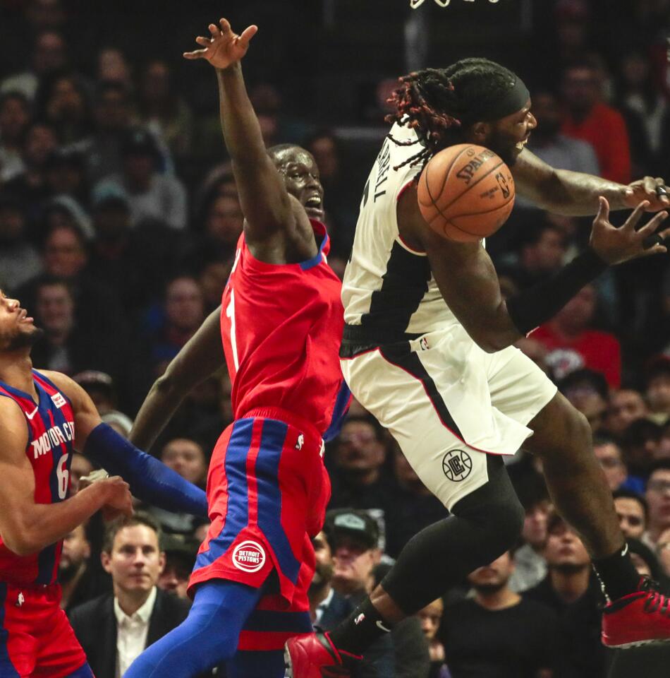 Clippers forward Montrezl Harrell, right, is fouled by Detroit Pistons guard Reggie Jackson during the second half.