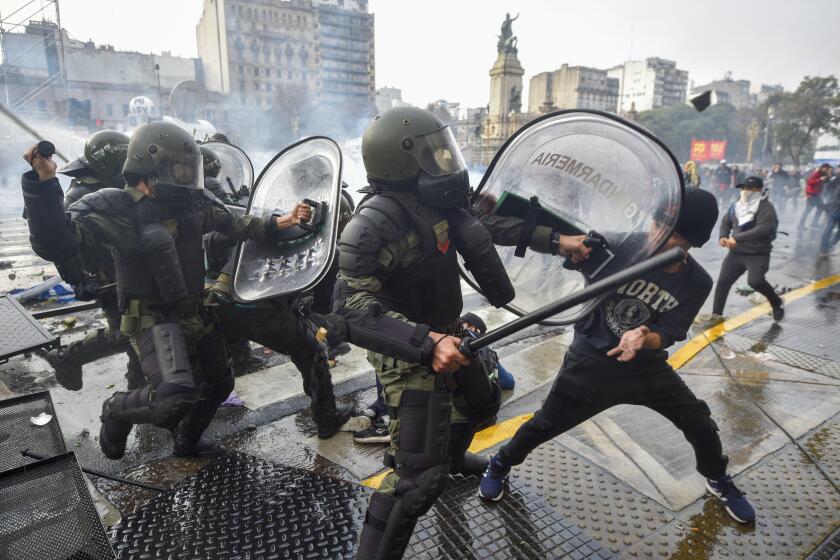 Anti-government protesters clash with police outside Congress, as lawmakers debate a reform bill promoted by Argentine President Javier Milei in Buenos Aires, Argentina, Wednesday, June 12, 2024. (AP Photo/Gustavo Garello)