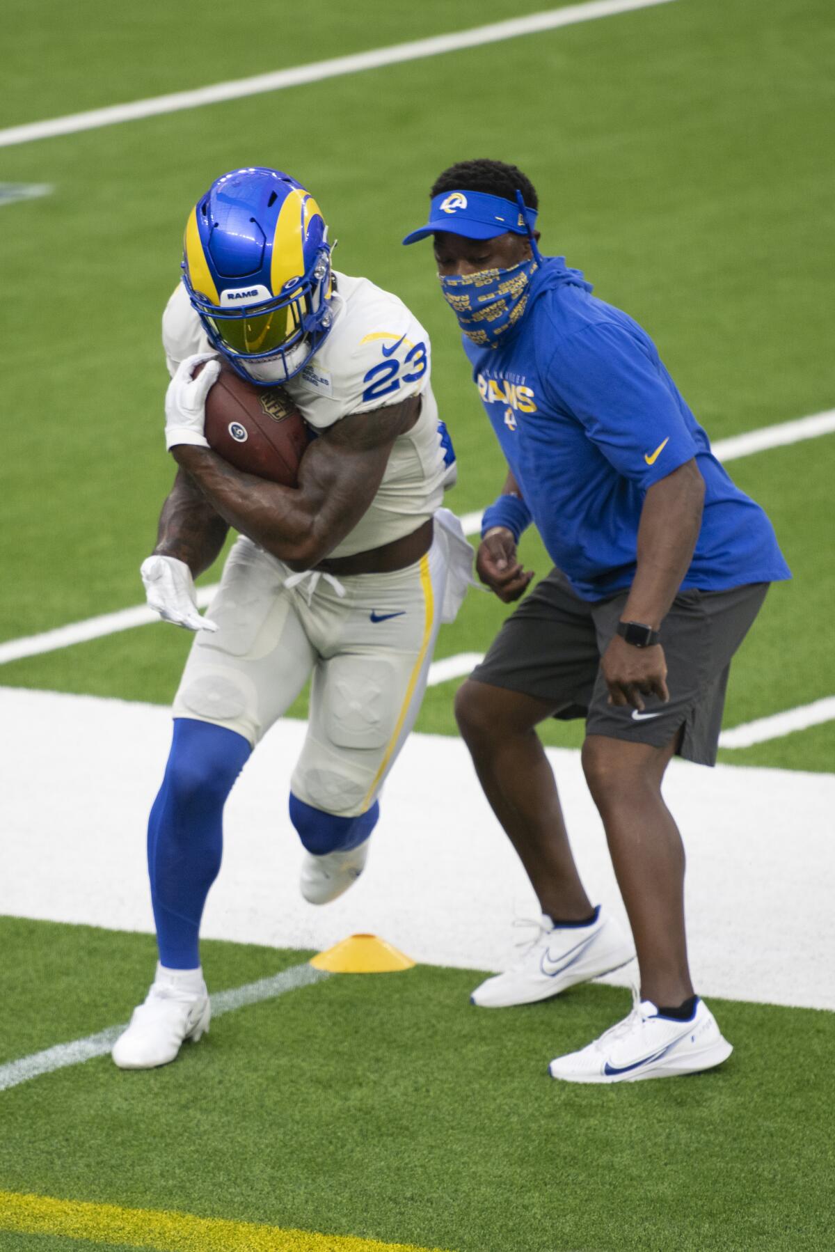  Rams running back Cam Akers, left, works on a drill as running back coach Thomas Brown watches. 