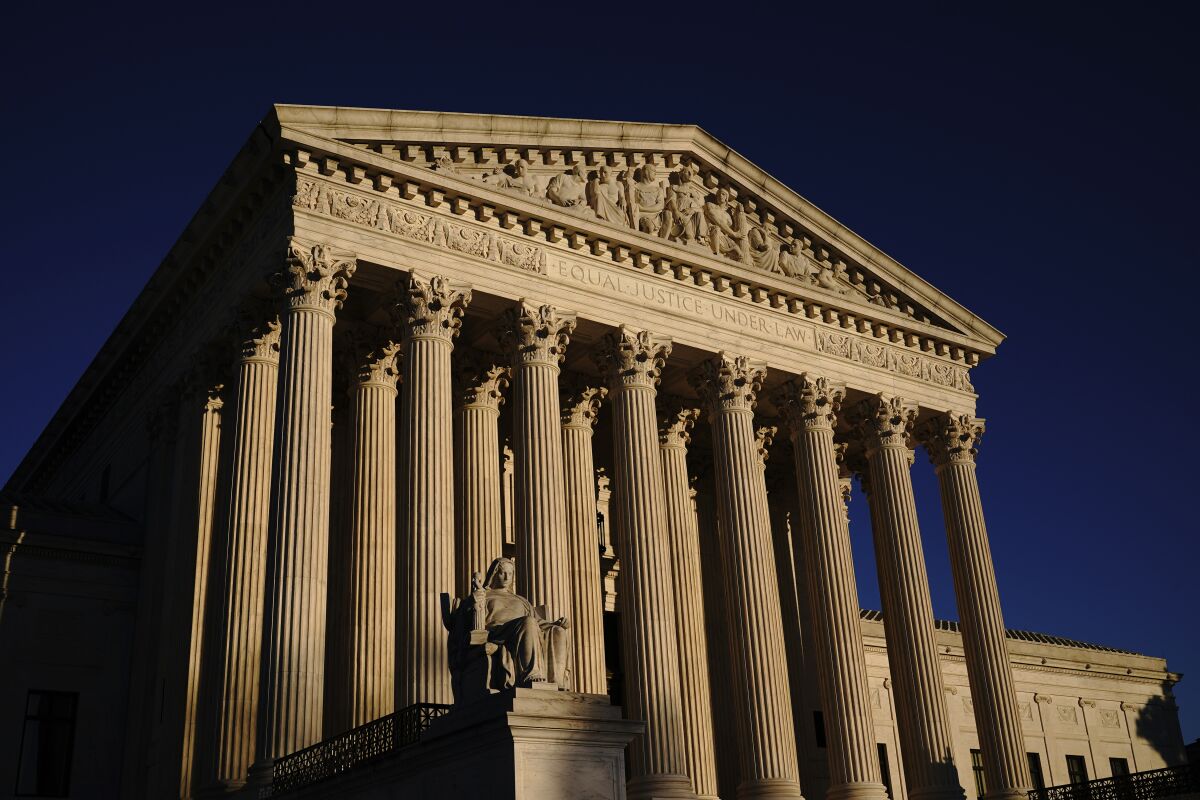 Exterior view of the Supreme Court columns and statue.