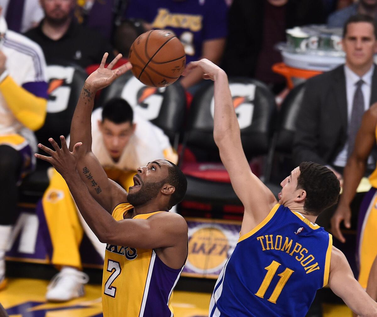 Wayne Ellington has a shot blocked by Klay Thompson of Golden State during the first quarter of the Lakers' 115-105 win Tuesday at Staples Center.