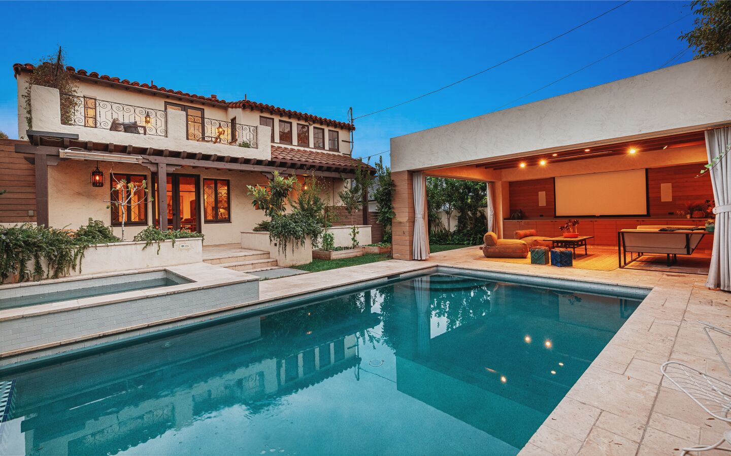 The swimming pool with a view of the house and a cabana.