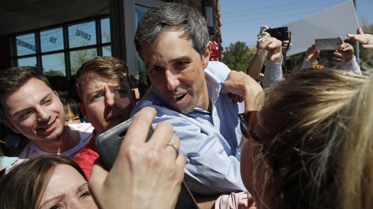 Democratic presidential candidate Beto O'Rourke stops for a photo in a crowd at a campaign stop at a coffee shop in Las Vegas.