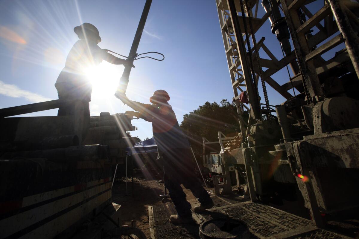 Water driller Steve Arthur's crew works on a well that will provide water for an orange grove in Terra Bella, Calif.