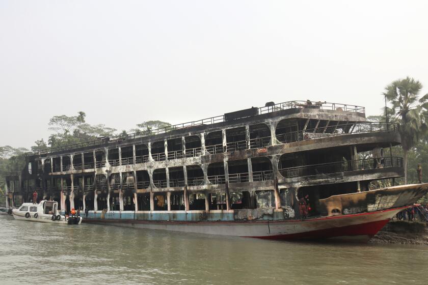 A burnt passenger ferry is seen anchored off the coast of Jhalokati district on the Sugandha River in Bangladesh, Friday, Dec. 24, 2021. Bangladesh fire services say at least 37 passengers have been killed and many others injured in a massive fire that swept through a ferry on the southern Sugandha River. The blaze broke out around 3 a.m. Friday on the ferry packed with 800 passengers. (AP Photo)