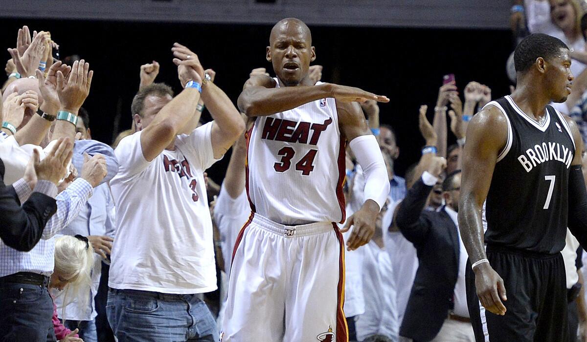 Heat guard Ray Allen (34) and Nets guard Joe Johnson (7) react after Allen hit a key three-point shot late in the fourth quarter of Game 5 on Wednesday night in Miami.