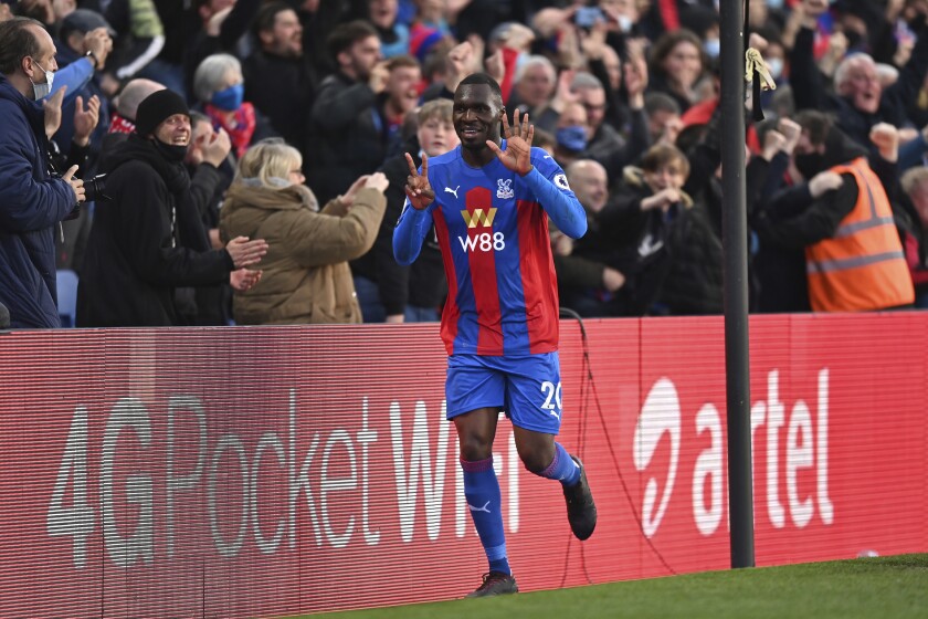 Crystal Palace's Christian Benteke celebrates after scoring his side's opening goal during the English Premier League soccer match between Crystal Palace and Arsenal, at Selhurst Park in London, England, Wednesday, May 19, 2021. (Justin Setterfield/Pool Photo via AP)