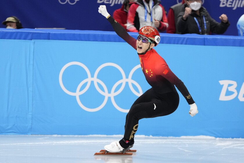 Wu Dajing of China reacts after crossing the finish line to win the mixed team relay final during the short track speedskating competition at the 2022 Winter Olympics, Saturday, Feb. 5, 2022, in Beijing. (AP Photo/Natacha Pisarenko)