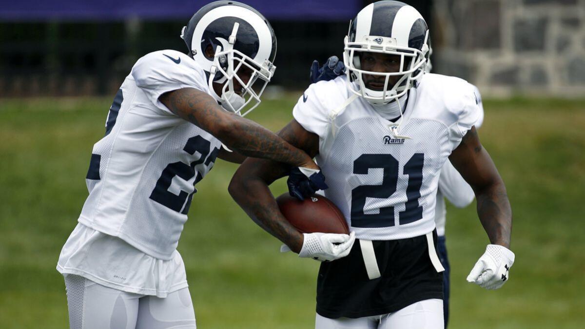 Rams cornerback Marcus Peters, left, tries to knock a ball loose from teammate Aqib Talib's possession during a drill at a joint training camp practice at the Baltimore Raven's headquarters on Tuesday in Owings Mills, Md.