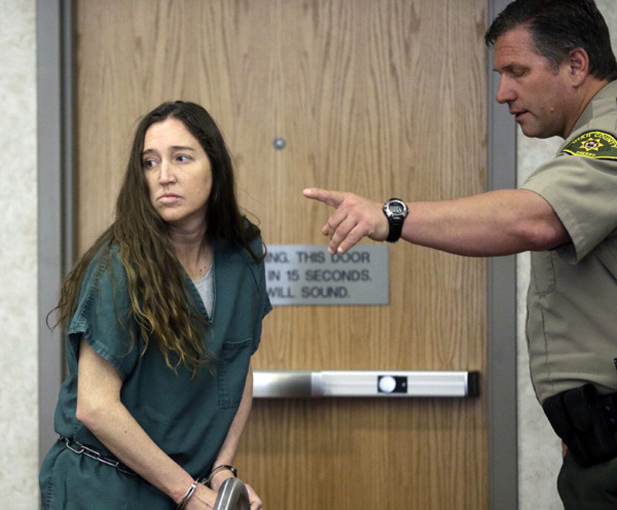 Megan Huntsman, accused of killing six of her babies and storing their bodies in her garage, appears in court on Monday in Provo, Utah.