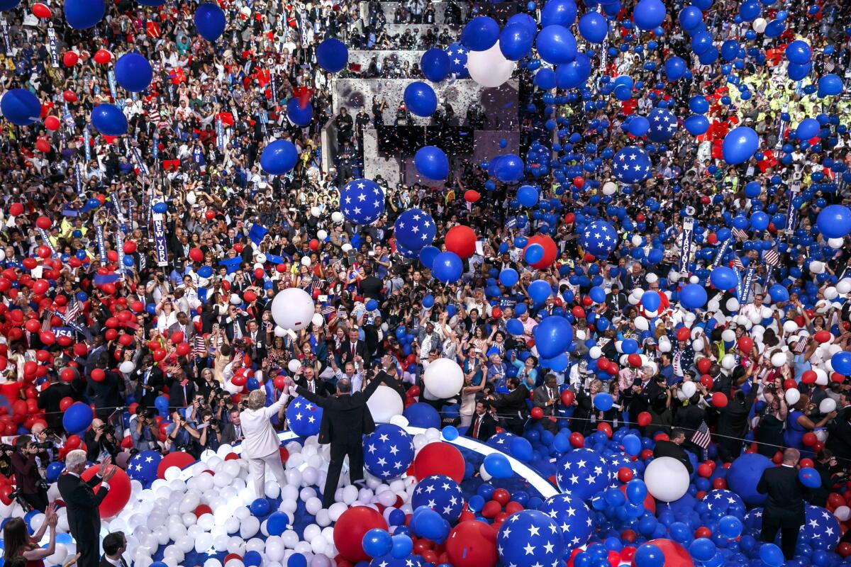 Balloons and confetti fall as Hillary Clinton and Senator Tim Kaine appear before the crowd at the end of the Democratic National Convention in Philadelphia.