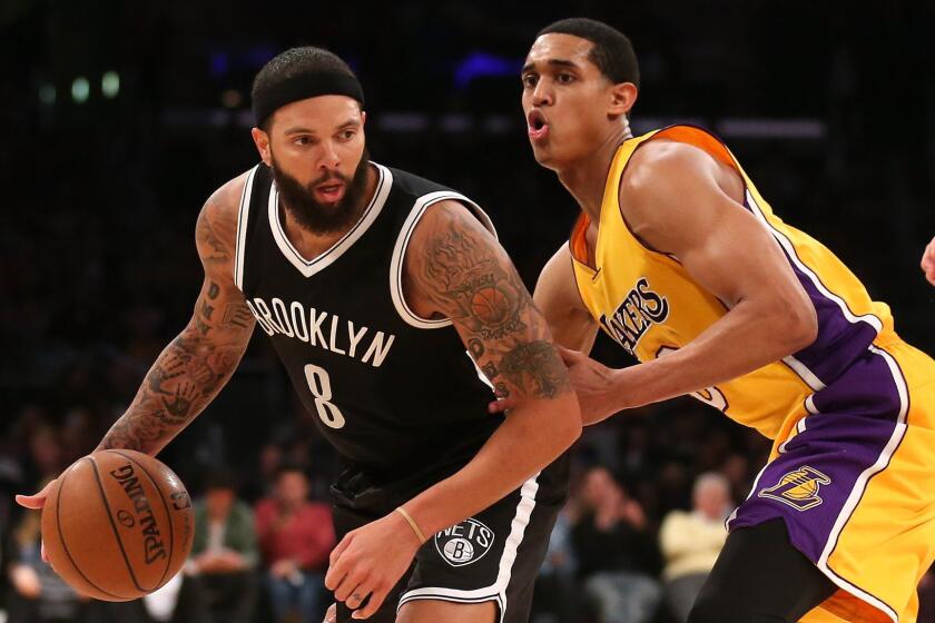 Brooklyn Nets guard Deron Williams, left, controls the ball in front of Lakers guard Jordan Clarkson during the Lakers' loss at Staples Center on Feb. 20.