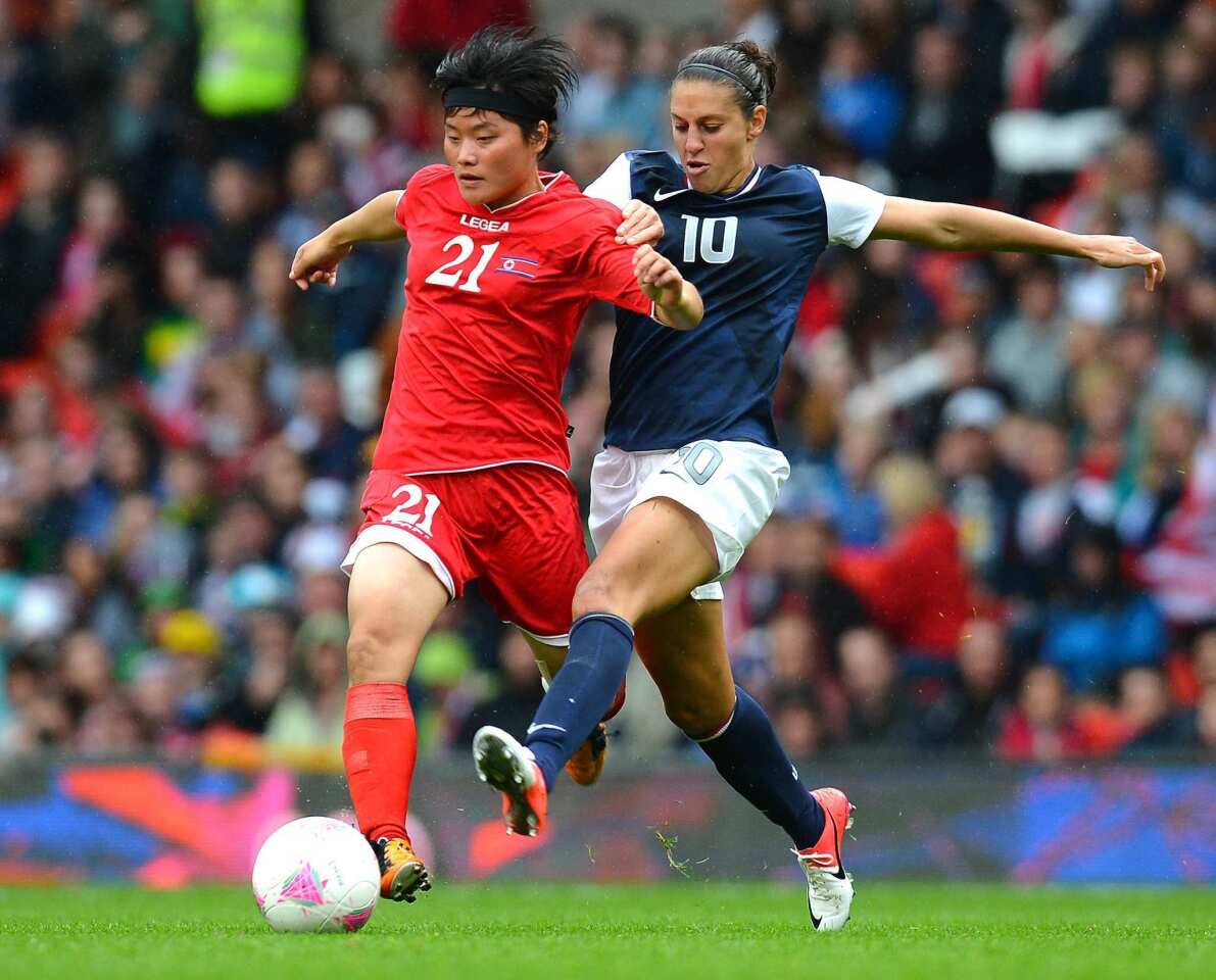 North Korea's Kim Su Gyong, left, is challenged by U.S. midfielder Carli Lloyd during the London Olympics.