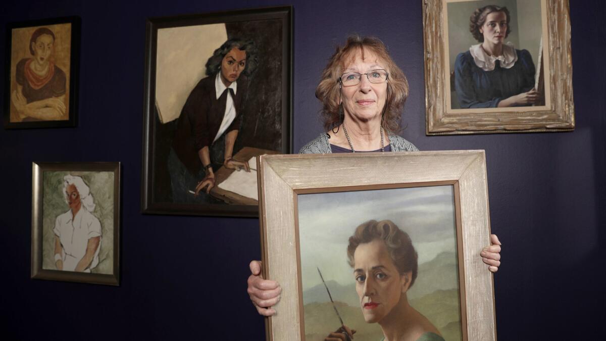 Maurine St. Gaudens, holding a self-portrait by Ruth Miller Kempster.