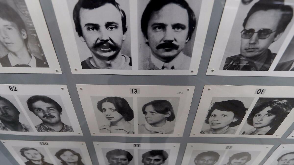Passport photos used by border guards in East Berlin hang on the wall of the Wende.