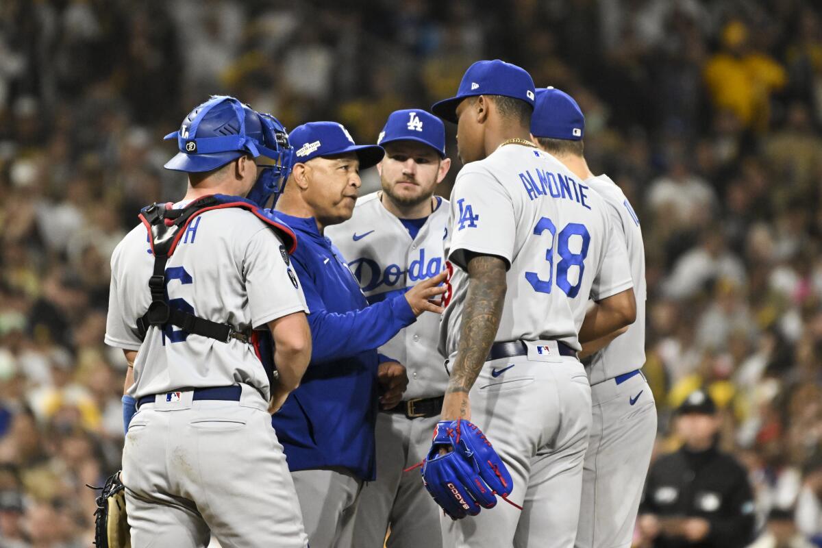 Dodgers manager Dave Roberts surrounded by Dodgers players.