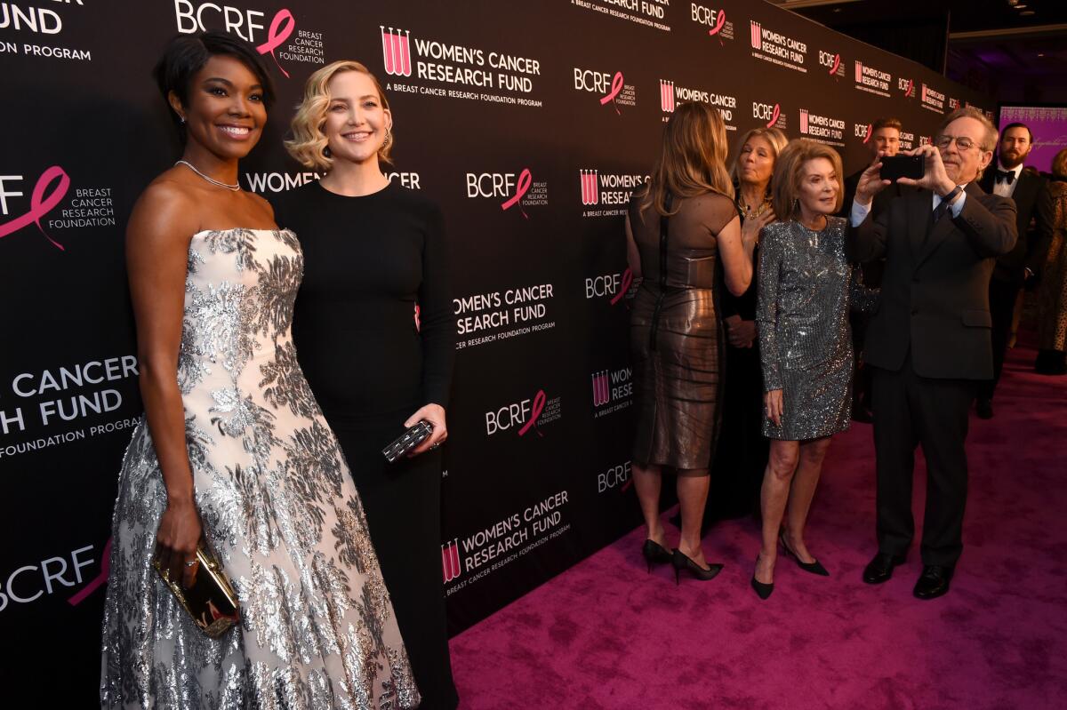 Honorees Gabrielle Union, left, and Kate Hudson with Marion Laurie, far right, and Steven Spielberg at WCRF's An Unforgettable Evening at the Beverly Wilshire on Thursday.