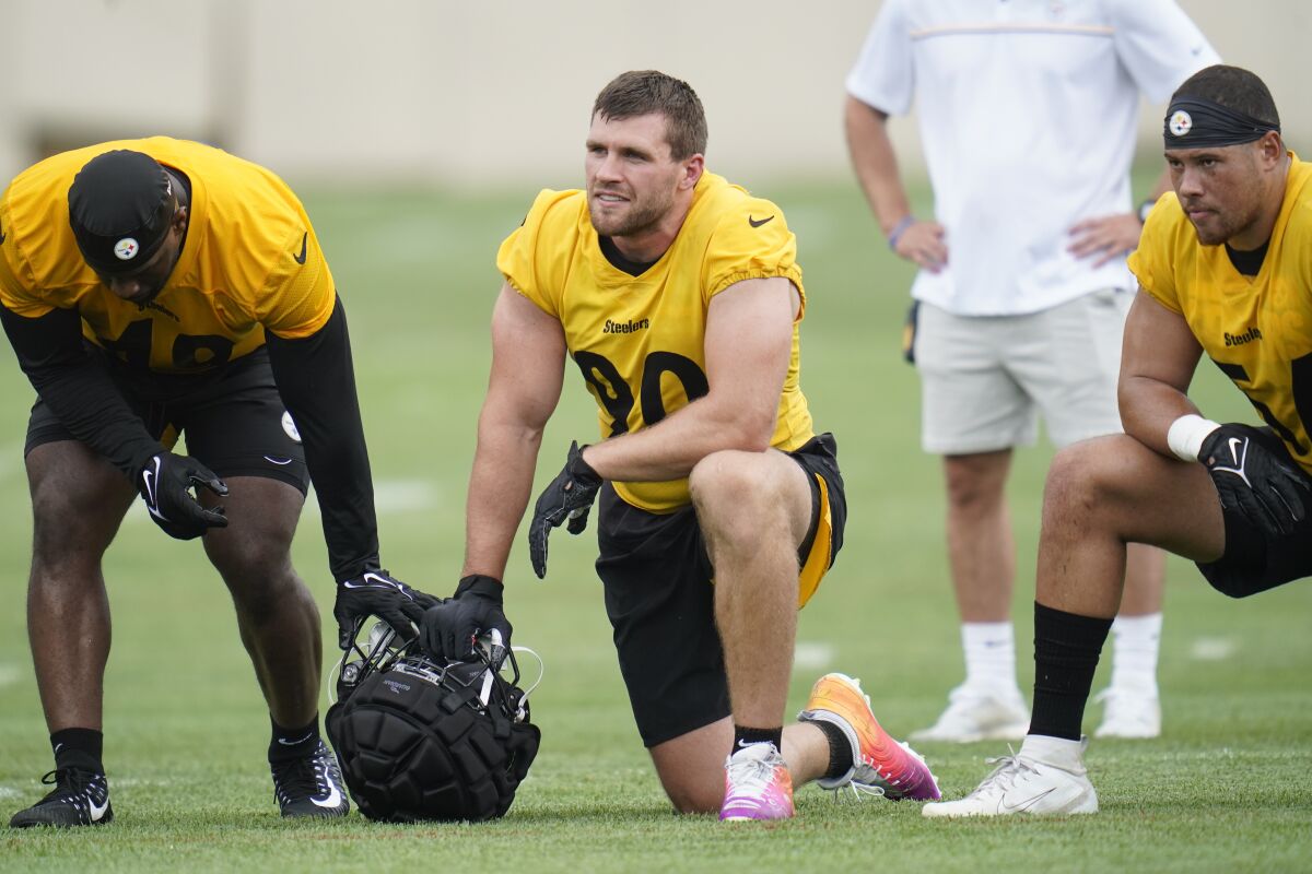 FILE - Pittsburgh Steelers linebacker T.J. Watt (90) watches drills during practice at the NFL football team's training camp in Latrobe, Pa., Wednesday, July 27, 2022. Watt has the paycheck, the cachet and the hardware. (AP Photo/Keith Srakocic, File)