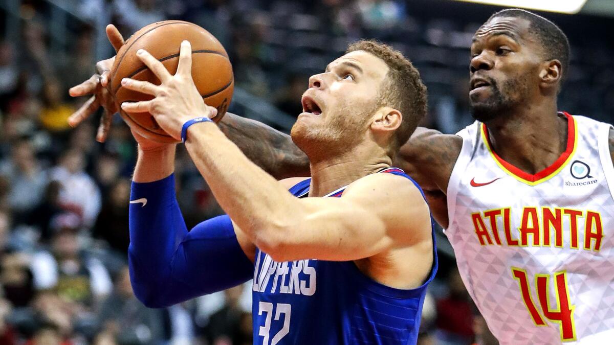 Clippers forward Blake Griffin tries to power his way past Hawks center Dewayne Dedmon during the first half Wednesday.