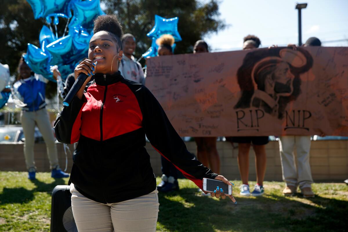 amryn Johnson raps during a memorial event for Nipsey Hussle