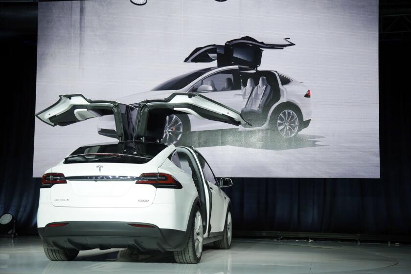 The Tesla Model X is unveiled Sept. 29 at an event in Fremont. The company said it delivered 208 of the vehicles in its fourth quarter.