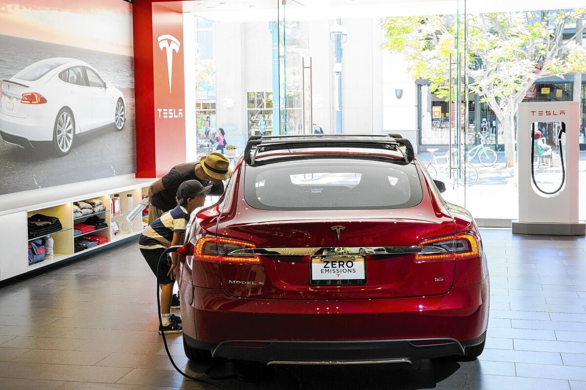 California rebates have encouraged many car shoppers to buy Tesla's premium electric Model S, which starts at about $71,000, a Tesla executive says. Above, Tesla's Santa Monica showroom.