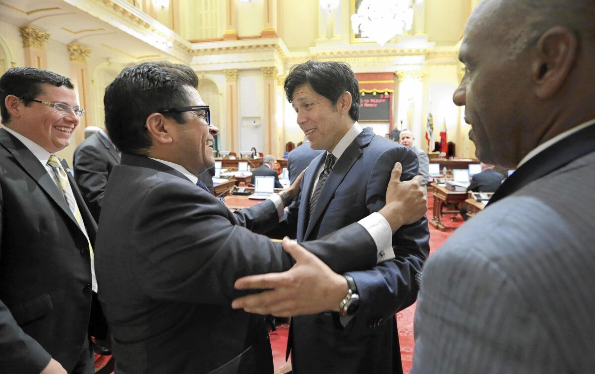 Sen. Kevin de Leon (D-Los Angeles), second from right, receives congratulations from Assemblyman Jimmy Gomez (D-Los Angeles), second from left, after he was elected as the new Senate President Pro Tem at the Capitol.