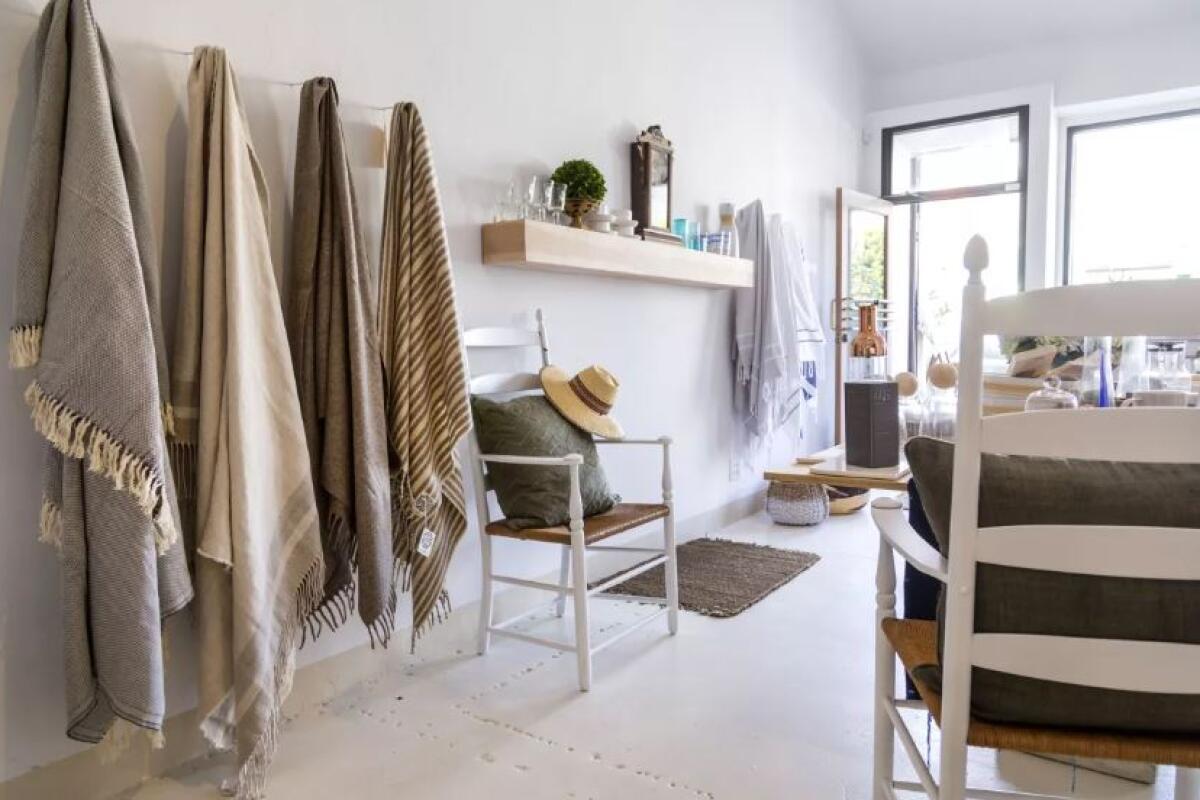 Fringed blankets and Turkish bath towels share wall space at Motti Casa