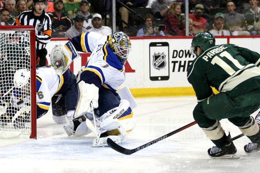 Wild left wing Zach Parise (11) scores his second goal of the game Sunday, beating Blues goalie Brian Elliott in the third period.