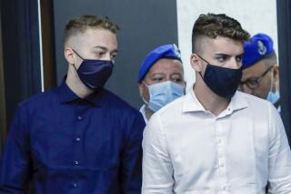 Gabriel Natale-Hjorth, right, and Finnegan Lee Elder arrive for a court hearing in Rome on Wednesday.