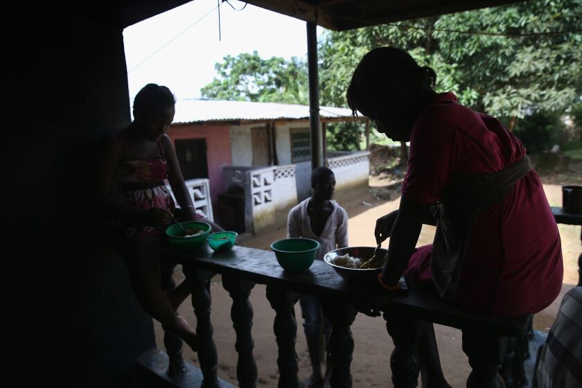 Family members of Marthalene Williams, the woman who most likely infected Eric Duncan, the first Ebola patient to develop symptoms in the United States, eat lunch at the home in Liberia where she died.
