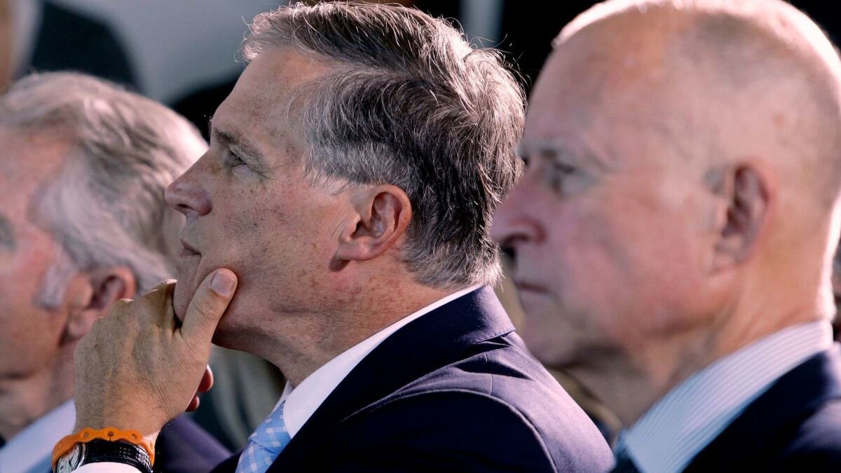 Washington Gov. Jay Inslee and California Gov. Jerry Brown listen to a speaker in San Francisco before signing an agreement to collectively combat climate change in 2013.