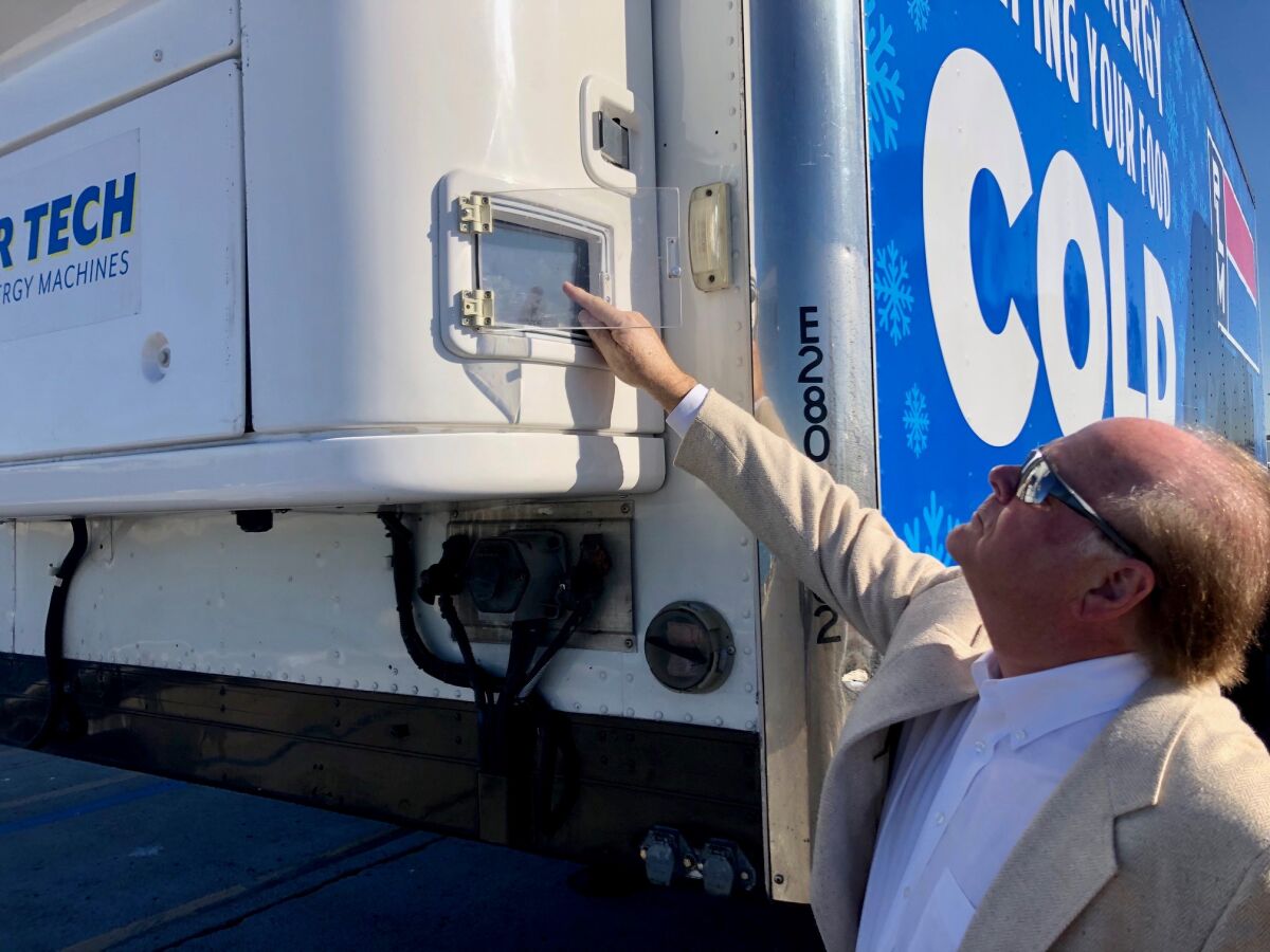 Robert Koelsch, CEO of Advanced Energy Machines, turns on one of his company's zero-emissions refrigerated storage units at the unveiling of California's Clean Off-Road Equipment Voucher Incentive Project, also known as CORE, at a news conference at the Port of San Diego on Friday, Jan. 31, 2020.